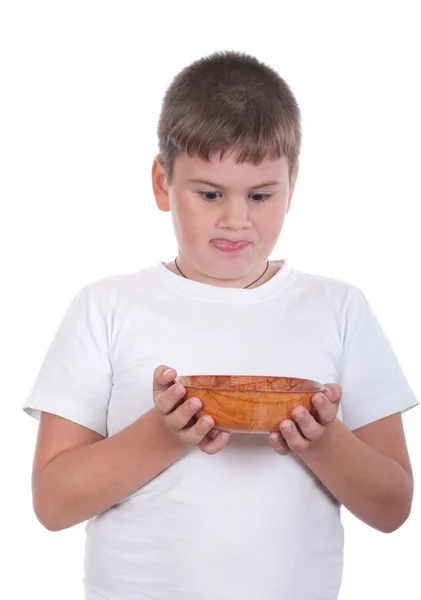 Rapaz é apetitoso olha para um prato — Fotografia de Stock