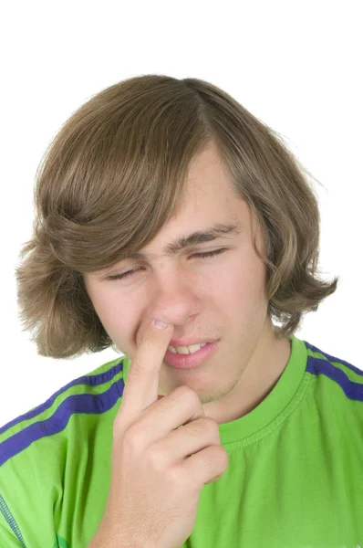 Teenager digs in a nose — Stock Photo, Image