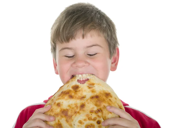 Kleine jongen bijt brood — Stockfoto