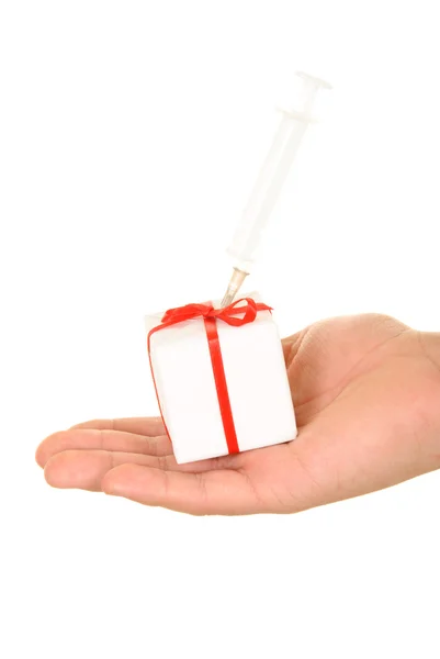Syringe in gift on palm — Stock Photo, Image