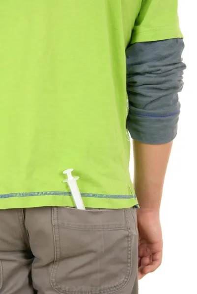 Stříkačka spočívá v kapse kalhot — Stock fotografie