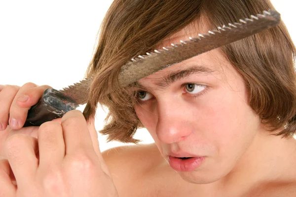 Teenager cuts off saw hair — Stock Photo, Image