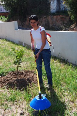 Young farmer fertilizing the soil clipart