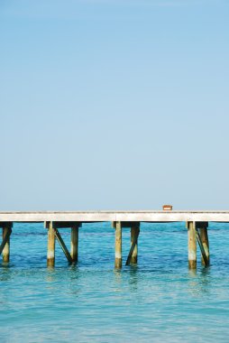 Wooden jetty bridge on a beautiful Maldi clipart