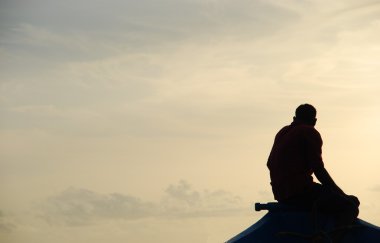 Silhouette of a fisherman on a typical D clipart