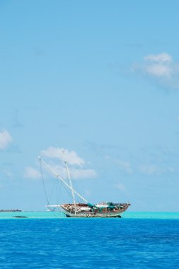 Semi-submerged typical ship on Maldives clipart