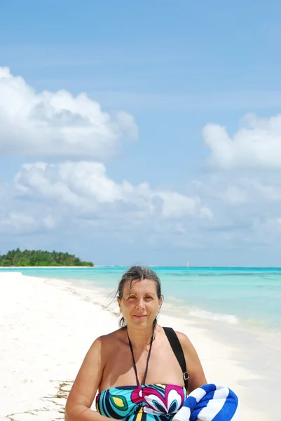 Beautiful senior woman walking on a trop — Stock Photo, Image