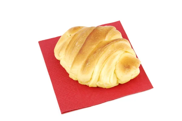 One fresh croissant on a red napkin — Stock Photo, Image