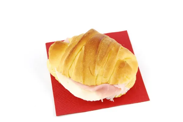 Cheese and ham croissant on a red napkin — Stock Photo, Image