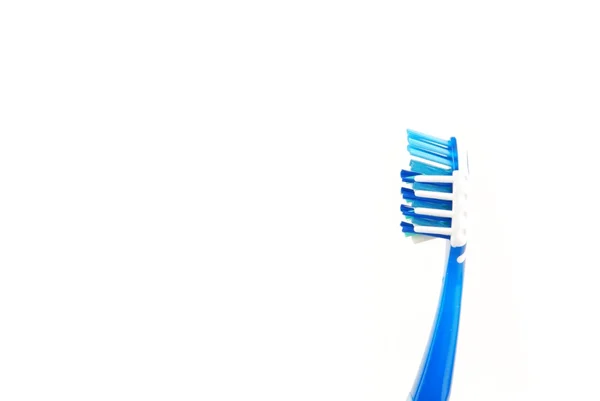 Синяя и белая зубная щетка — стоковое фото