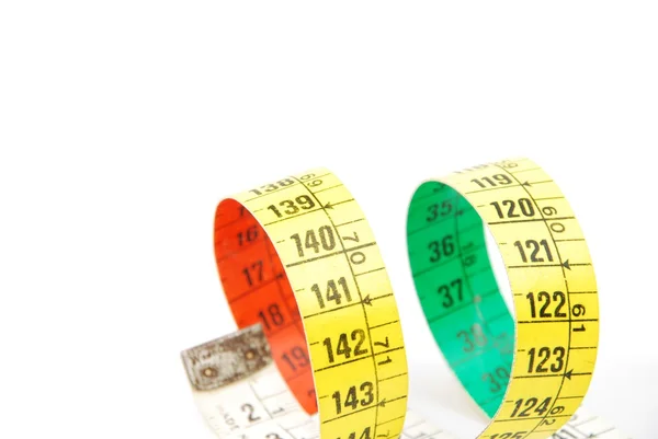 Curled measuring tape on white — Stock Photo, Image