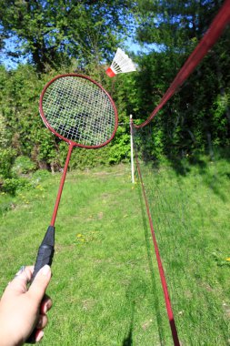 Playing badminton outdoors clipart