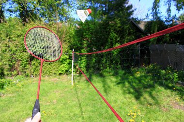 Playing badminton outdoors clipart