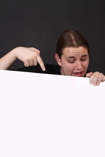 Teen pointing at blank sign — Stock Photo, Image