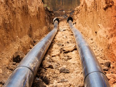 Pipes for water in a trench clipart