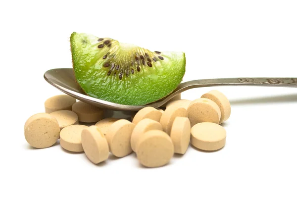 Heap of tablets and kiwi — Stock Photo, Image
