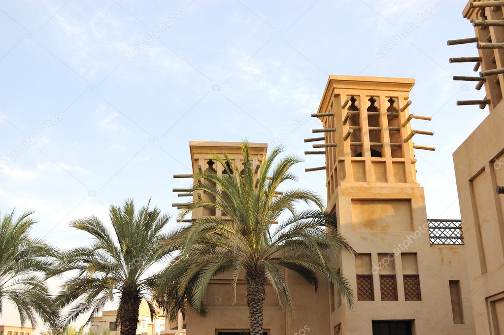 Arabic building with wind towers during