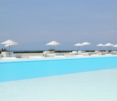 Swimming pool area at ultra modern hotel clipart