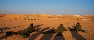 Israeli soldiers excersice in a desert clipart