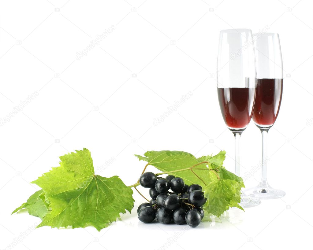Black grapes and tall wine glasses isola