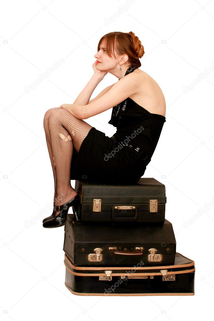 Woman sitting on suitcases