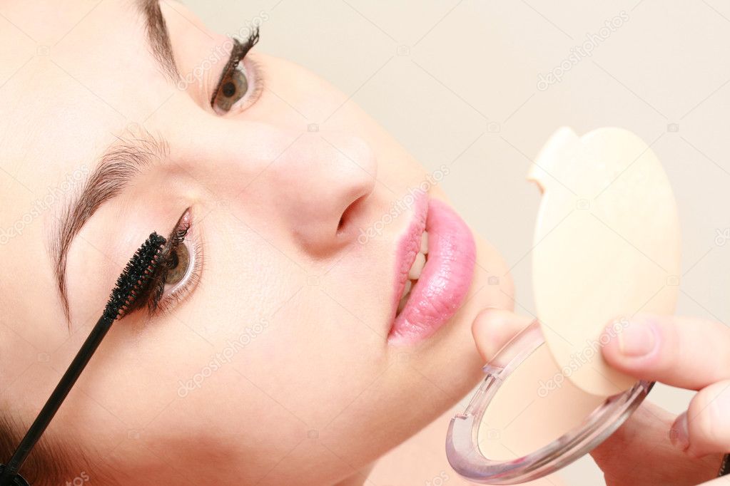 Woman Brushing on Mascara