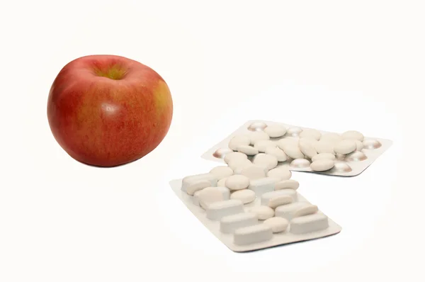 stock image Red apple with pills