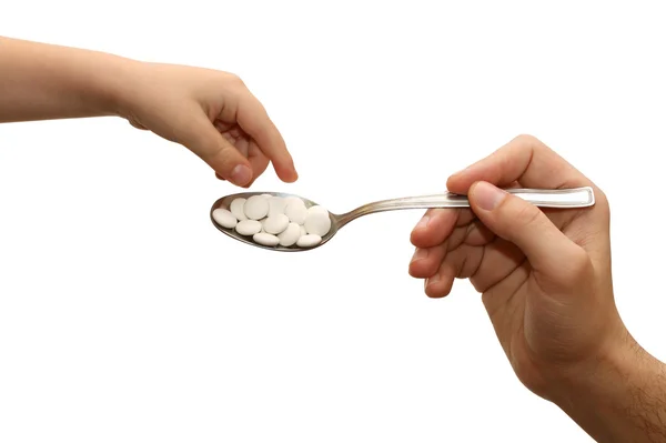Child takes the tablets with a spoon — Stock Photo, Image