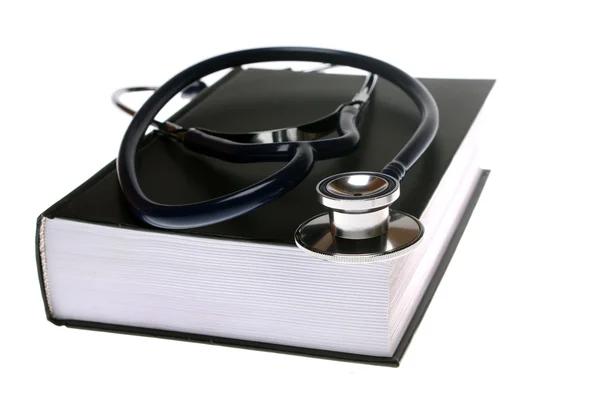 stock image Stethoscope on book