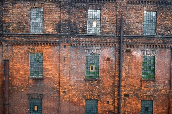 Red brick wall with mosaic windows — Stock Photo, Image