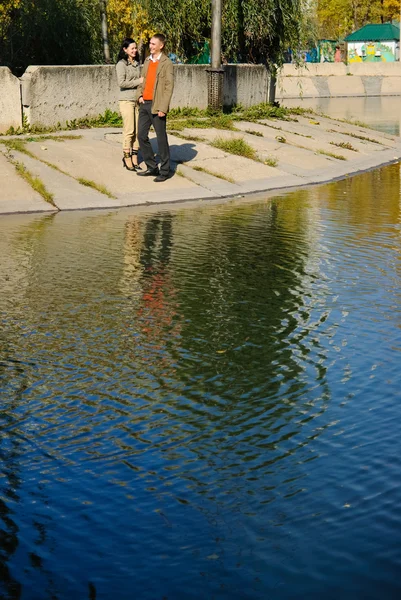 stock image Young couple staying near the water