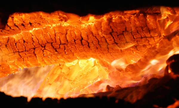 Las brasas ardientes de un fuego de leña — Foto de Stock