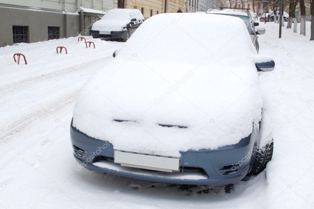 Parked car covered with snow