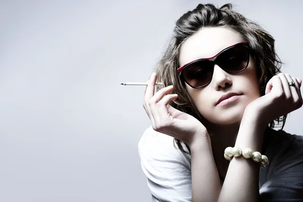 Красивая девушка курит сигарету — стоковое фото