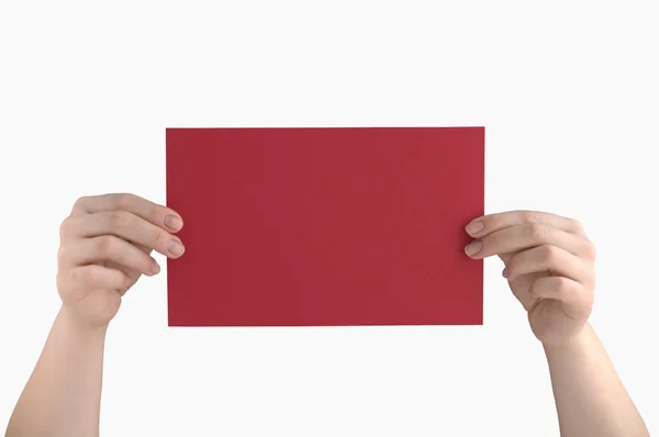 Red page in the hands — Stock Photo, Image