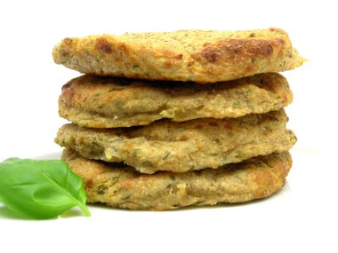 Potato dough cakes with basil lying upon clipart