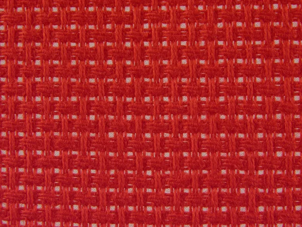 Tło włókienniczych holey w kolorze czerwonym — Zdjęcie stockowe