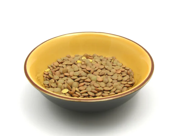 Lentils in a bowl of ceramic on white b — Stock Photo, Image