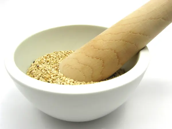 Sesame in a bowl of china ware with pest — Stock Photo, Image