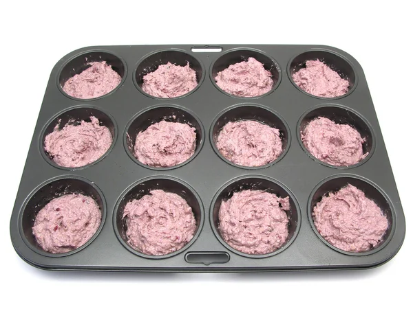 Raspberry muffins in a muffin cake pan b — Stock Photo, Image