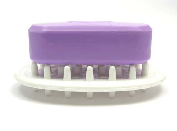 Lilac soap on a soap dish on a white bac — Stock Photo, Image