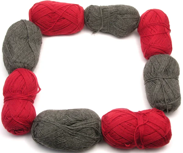 Gris y rojo lana nueva como marco en blanco —  Fotos de Stock