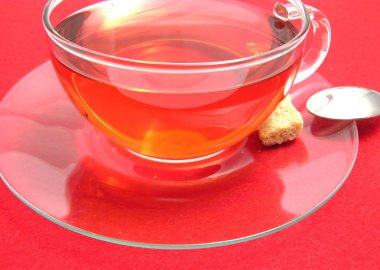 Tea cup with rose hip tea on a placemat clipart