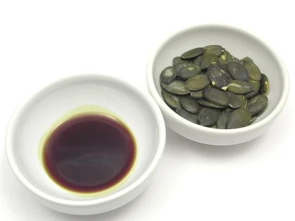 Two bowls of chinaware with pumpkin seed — Stock Photo, Image