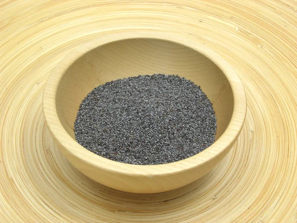 Wooden bowl with poppy seeds — Stock Photo, Image