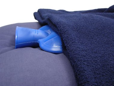 Hot-water bag wrapped in a blue blanket clipart