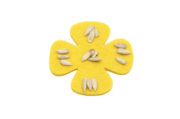 Sunflower seeds and felt decoration — Stock Photo, Image