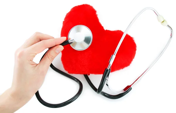 Hand with stethoscope checking a red hea — Stock Photo, Image