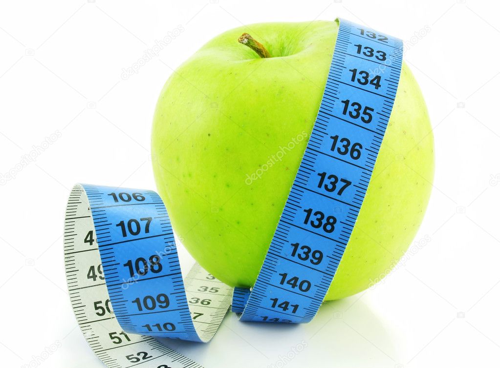 Bright green apple and measuring tape is
