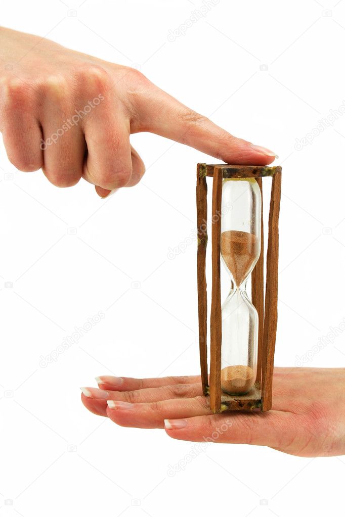 Female hand holds hourglass